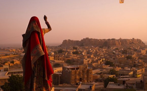 Photo: A girl flying a kite in