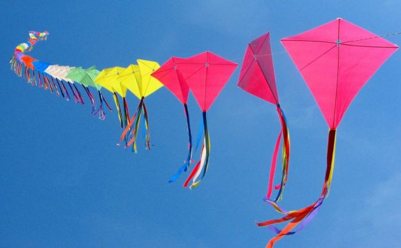 A rainbow-colored kite train