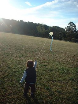Child Flying Kite - Aren trotting downwind with small Diamond.n